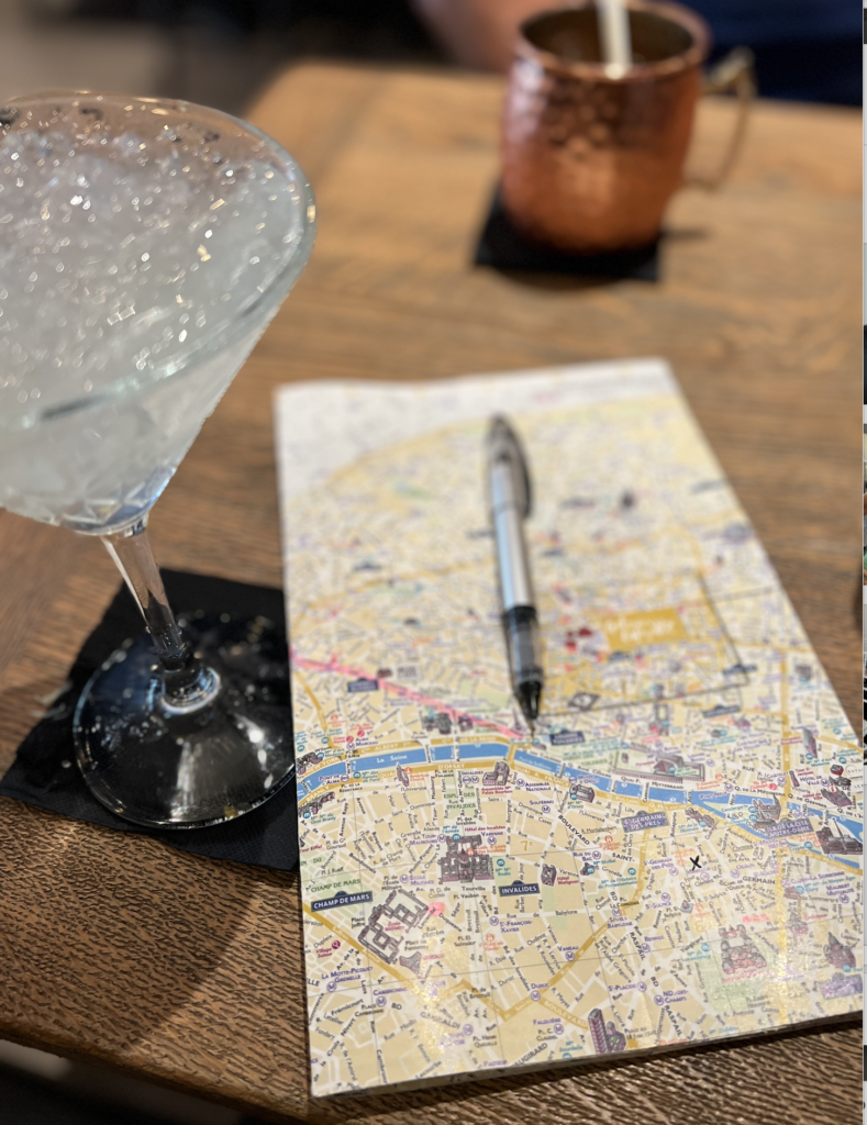 trip planning. map on table with pen and drink. travel like a designer